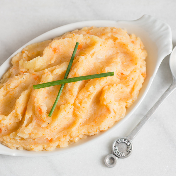 root vegetable mashed potatoes in a white dish